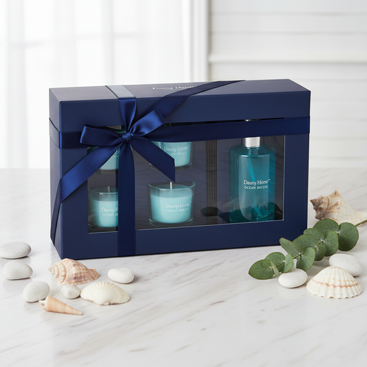 Danny Home Ocean Breeze luxury candle and diffuser gift set in navy ribbon box on marble with shells