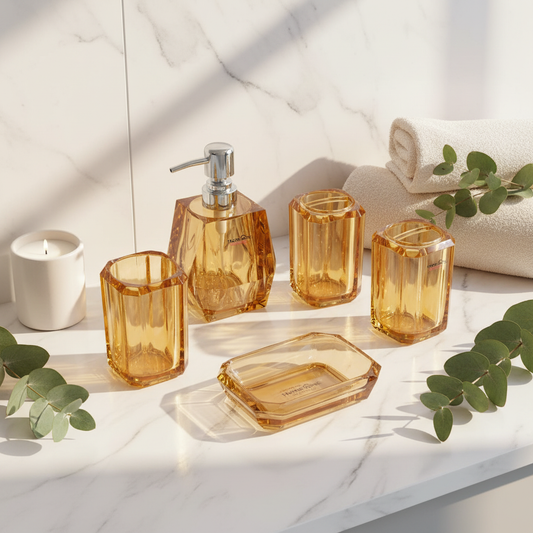 Amber crystal acrylic 4-piece bathroom set on white marble countertop