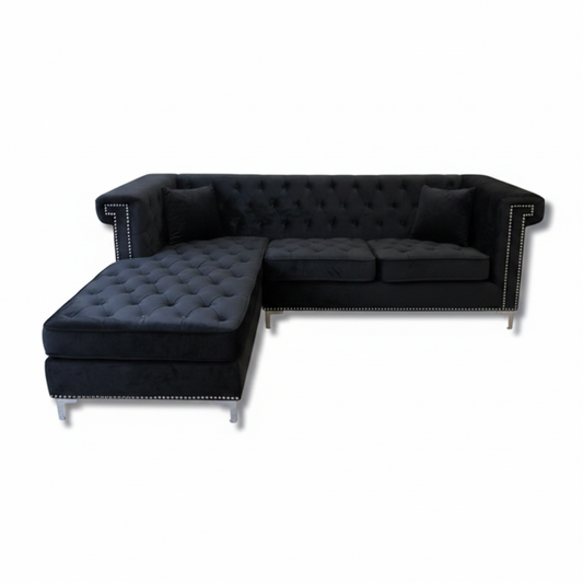 Black velvet tufted sofa on white background product shot